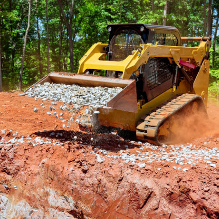 Equipment RentalsA close-up of a skidsteer dumping gravel out of it's bucket.